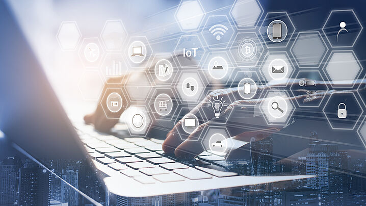 Image shows various icons related to software applications, with the icons floating above a laptop keyboard.