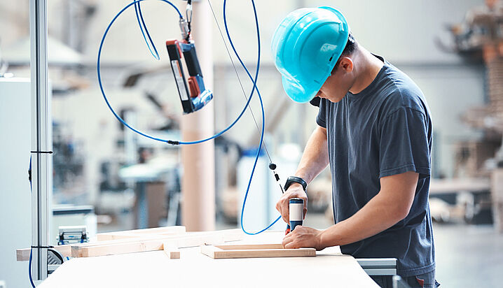 Picture of a production worker wearing a blue safety helmet