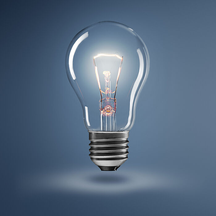 Image shows a light bulb against a dark background